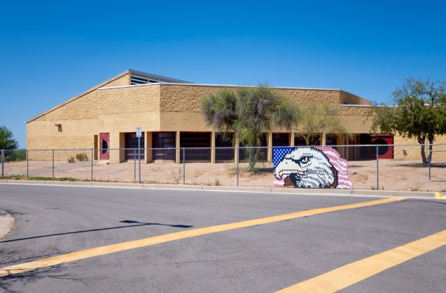 school building and fence with eagle banner