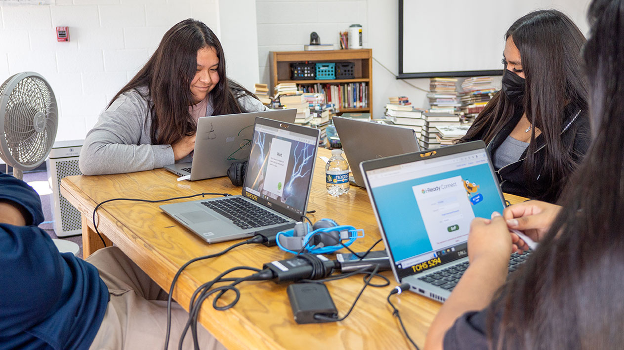 Students in a classroom using laptops. 